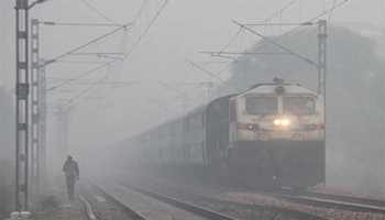 Fogged Journeys: Trains Crawl Across India  
